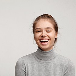 a woman smiling after undergoing teeth whitening