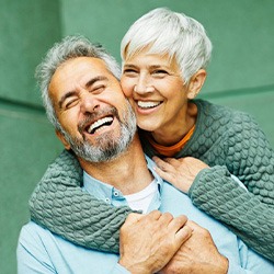 Couple smiling while embracing