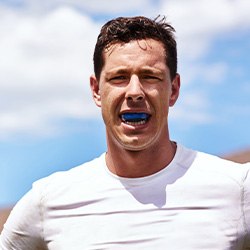 Man wears athletic mouthguard