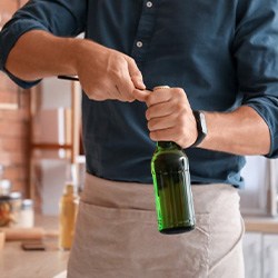 Man opens bottle with opener