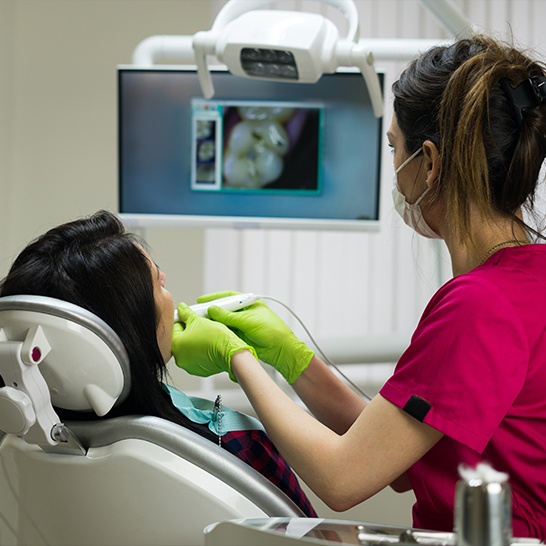 Dentist using intraoral camera to capture smile images