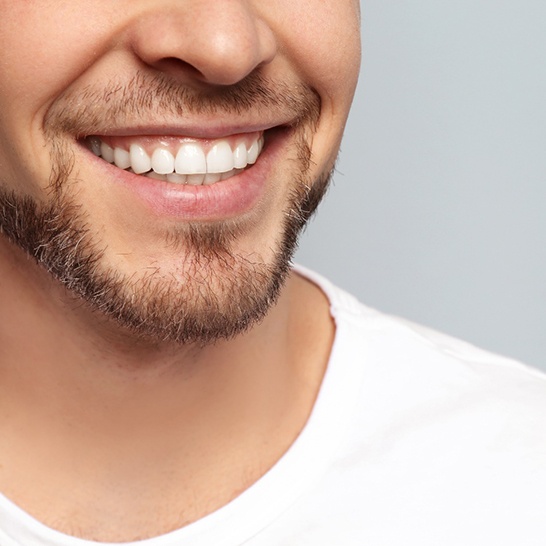 Man smiling with dental crown in Mission Viejo