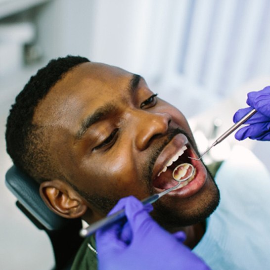 An African American man getting a dental checkup