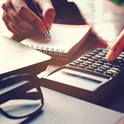 Woman using calculator and notepad