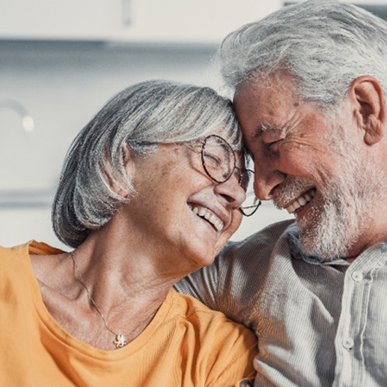 Happy couple smiling together after receiving affordable dentures in Mission Viejo 