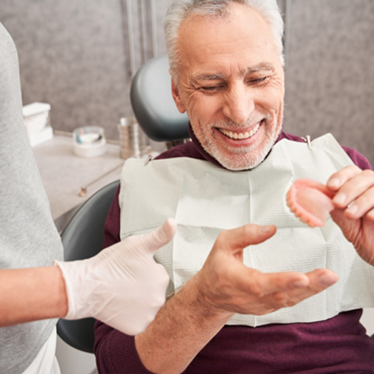 a patient and a dentist chatting about dentures