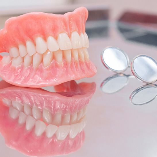 full dentures sitting on a counter 