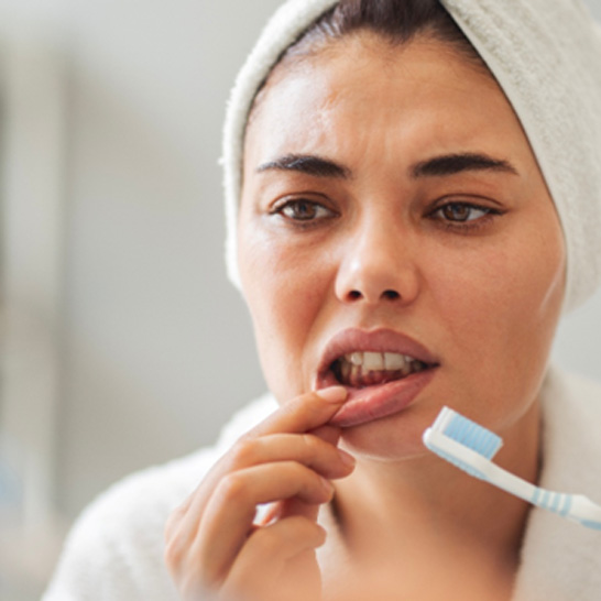 Patient looking concerned at their gums