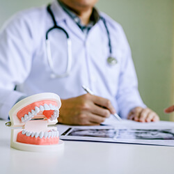 Dentist discussing dental X-ray with patient 