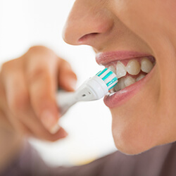 Close up of woman brushing her teeth 