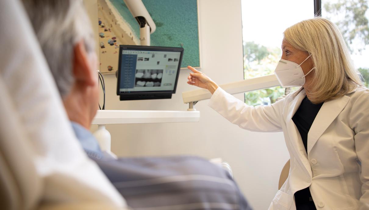 Dentist talking to patient during emergency dentistry