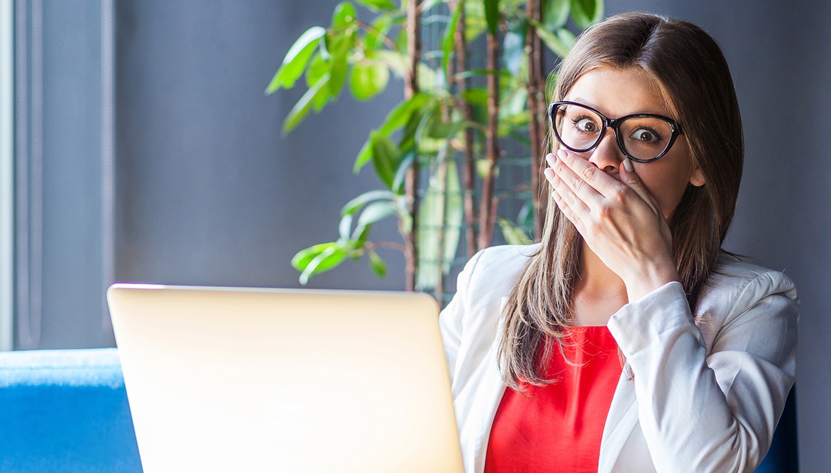 Fearful patient in need of sedation dentistry covering her mouth