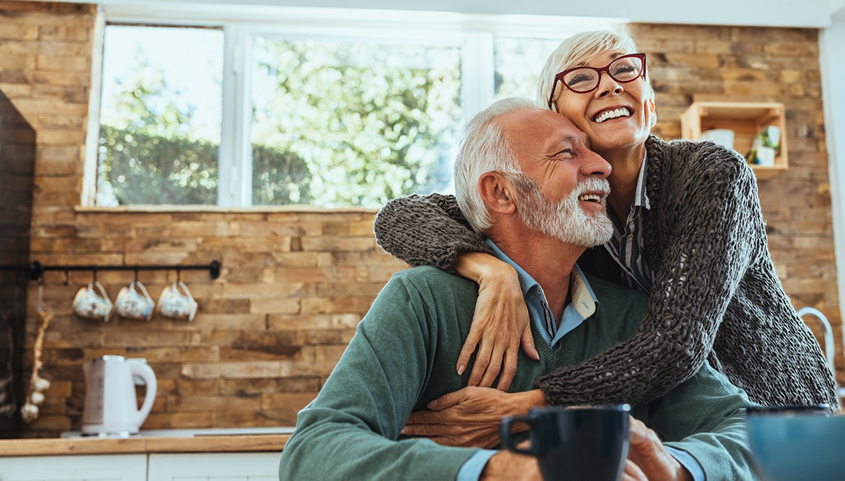 Man and woman smiling after restorative dentistry