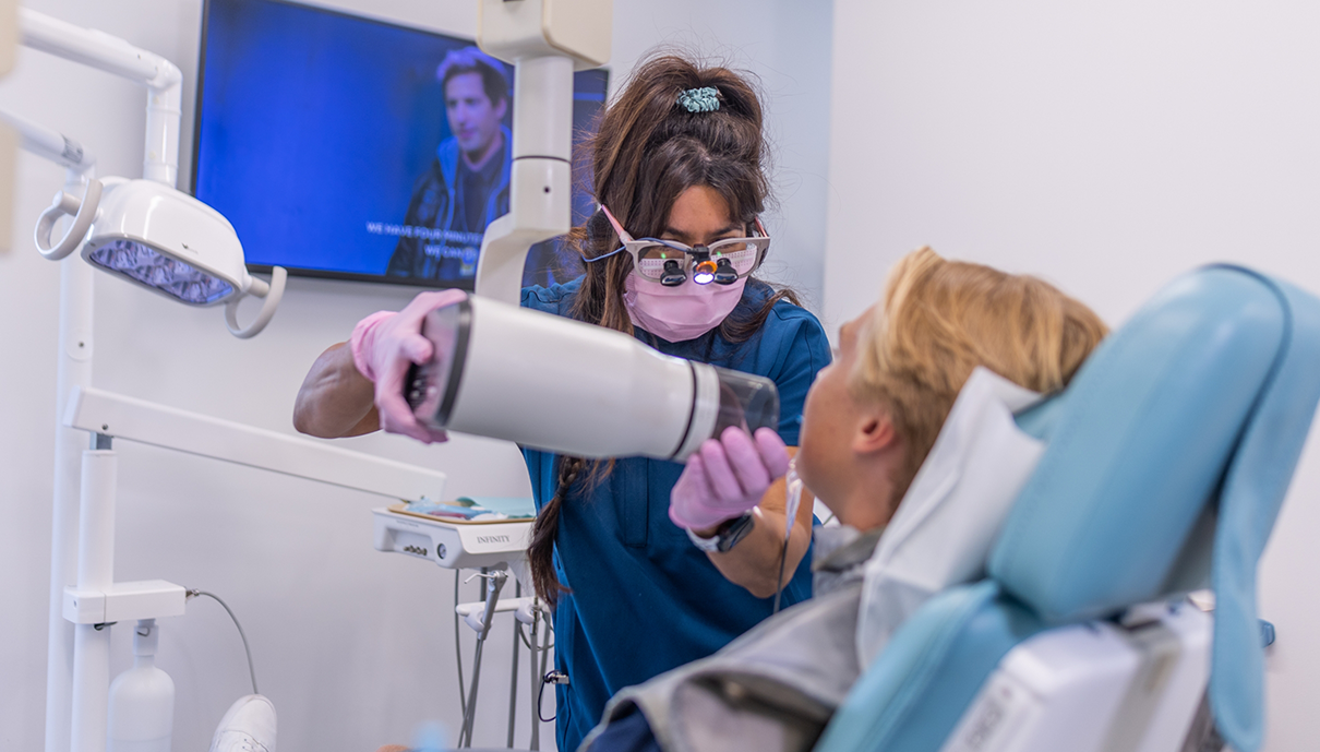 Man and woman smiling after restorative dentistry
