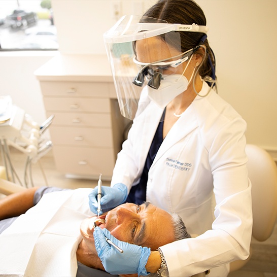 Patient receiving dental checkup and teeth cleaning