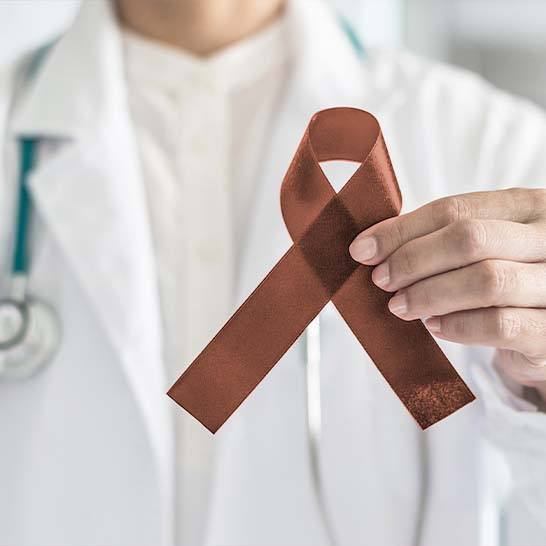 Dentist holding oral cancer awareness ribbon