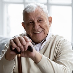 Man smiling while sitting on couch at home