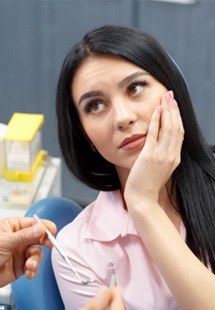woman visiting dentist for dental emergency 