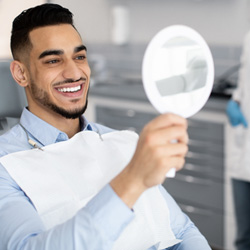 Man in treatment room smiling at reflection