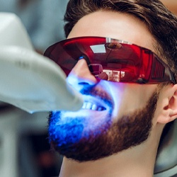 Man getting ZOOM! teeth whitening in Mission Veijo