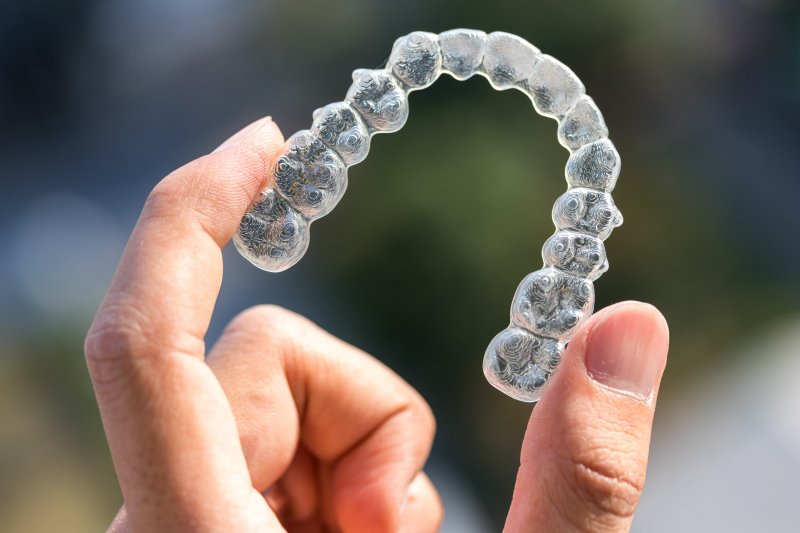 Close-up of person holding an Invisalign tray