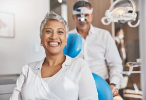 happy patient sitting in a dentist’s chair
