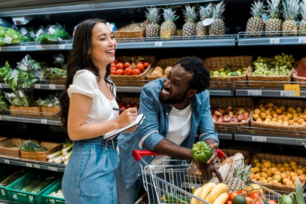 A couple grocery shopping for healthy food