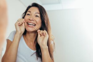 Woman flossing her teeth