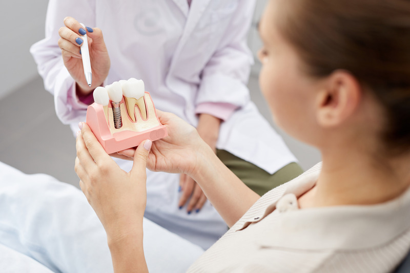 Patient talking to dentist about dental implants